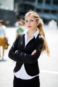 Portrait of young woman standing outdoors