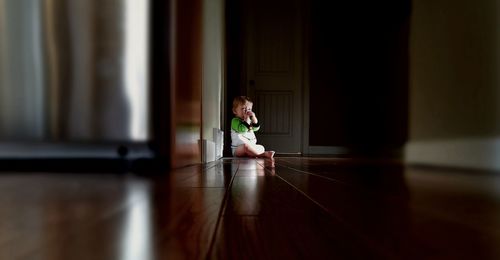 Boy sitting on floor at home