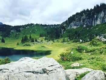 Scenic view of mountain against cloudy sky