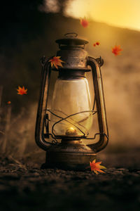 Close-up of illuminated lantern on metal