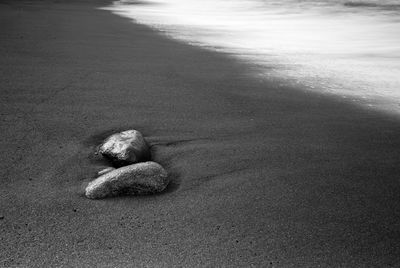 Long exposure shot of stones on black beach. 