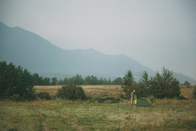 Scenic view of field man camping in the steppe against mountain