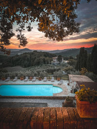 Scenic view of swimming pool against sky during sunset