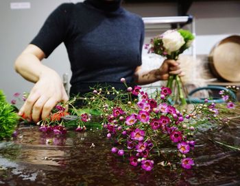Close-up of hand holding flowers