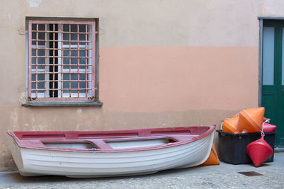 Boat and buoys on sidewalk outside building