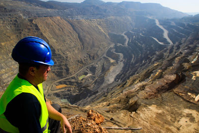 Engineer wearing hardhat on mountain 