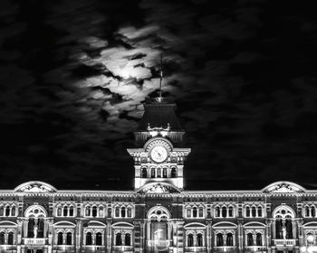 Low angle view of illuminated building against sky at night