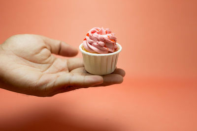 Close-up of hand holding ice cream