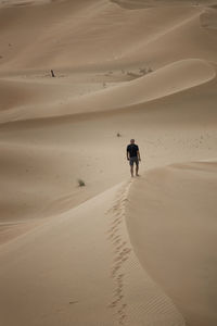 High angle view of man walking at desert