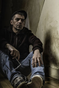 Portrait of man sitting on walkway