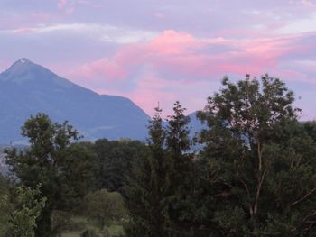 Scenic view of mountains against cloudy sky