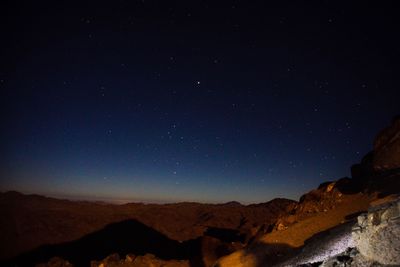 Scenic view of mountains against sky at night