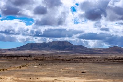Scenic view of mountains against cloudy sky