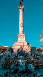 Low angle view of statue against blue sky