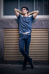 Young man with arms raised