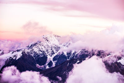 Scenic view of snowcapped mountains against cloudy sky