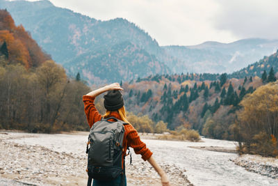 Rear view of man looking at mountains