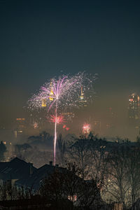 Firework display over city at night