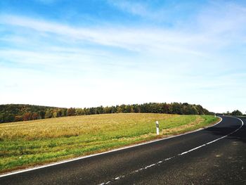 Road amidst field against sky in hungary 