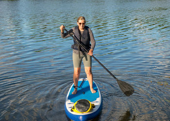 Full length portrait of woman standing in lake
