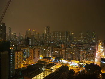 Illuminated cityscape against sky at night
