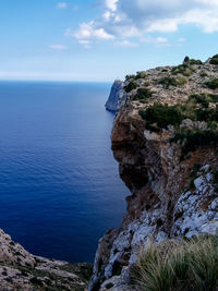 Close-up of rock by sea against sky