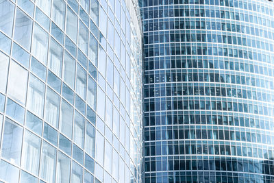 Low angle view of modern glass building in city