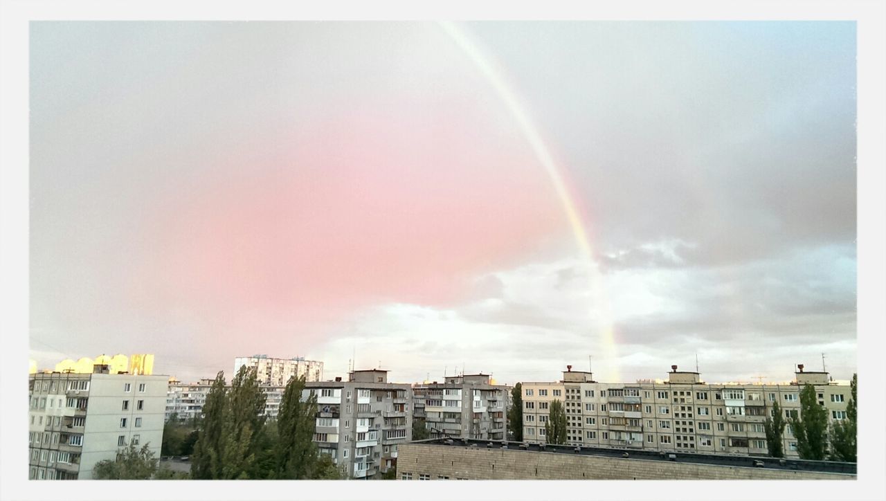 building exterior, architecture, built structure, city, transfer print, sky, rainbow, auto post production filter, residential building, cloud - sky, residential structure, residential district, cityscape, building, outdoors, house, cloud, no people, weather, city life