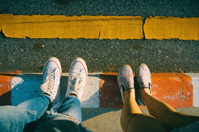 Low section of man standing on footpath