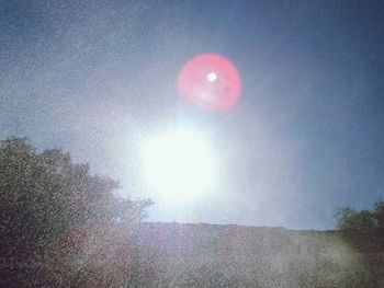 Low angle view of sun in sky
