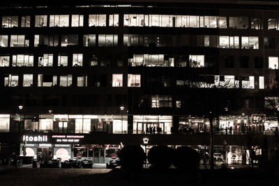 Woman standing in illuminated city at night