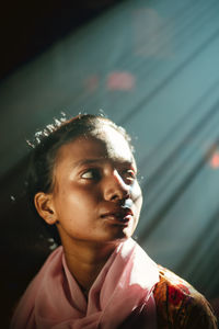 Window light to a young girl face who si looking way close shot