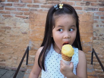 Portrait of cute girl eating food