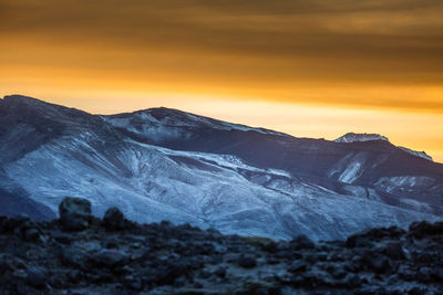 Scenic view of snowcapped mountains against sky during sunset