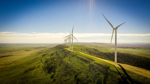 Windmill on field against sky
