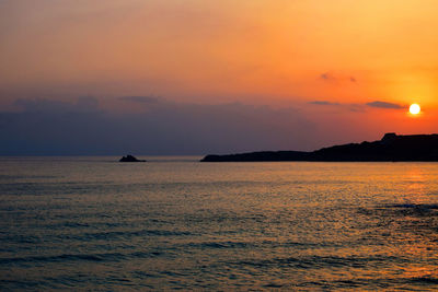 Scenic view of sea against orange sky