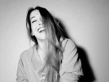 Close-up of a young woman against wall