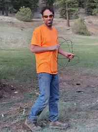 Full length of young man wearing sunglasses standing on land