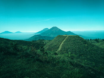 Scenic view of mountains against clear blue sky