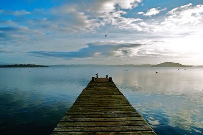 Pier over lake against sky