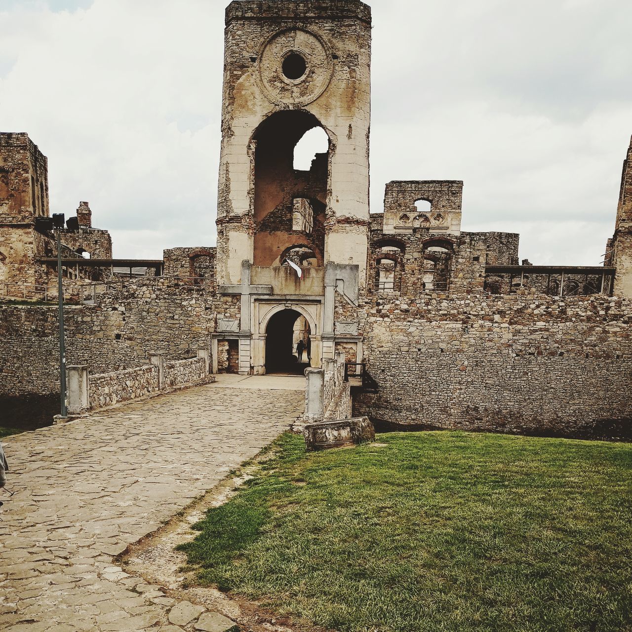 architecture, built structure, the past, history, arch, building exterior, sky, nature, building, old, day, grass, cloud - sky, no people, ancient, old ruin, travel destinations, travel, outdoors, tourism, ruined, stone wall, ancient civilization