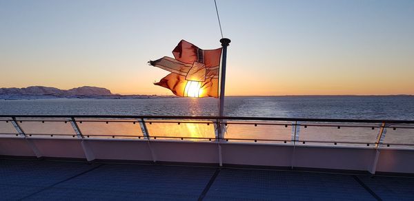 Scenic view of sea against clear sky during sunset