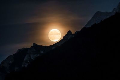 Scenic view of silhouette mountains against sky at night