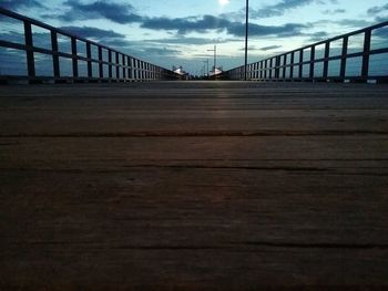 Surface level of road against cloudy sky