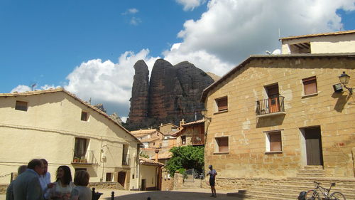 Buildings in city against cloudy sky