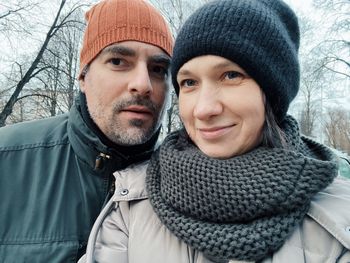 Portrait of young woman and mature beaded man wearing warm clothing