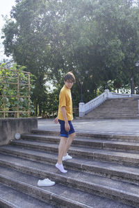 Full length side view of woman walking on staircase