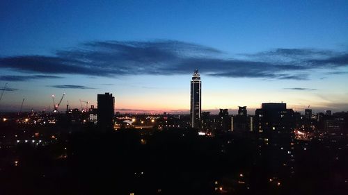 Cityscape against cloudy sky