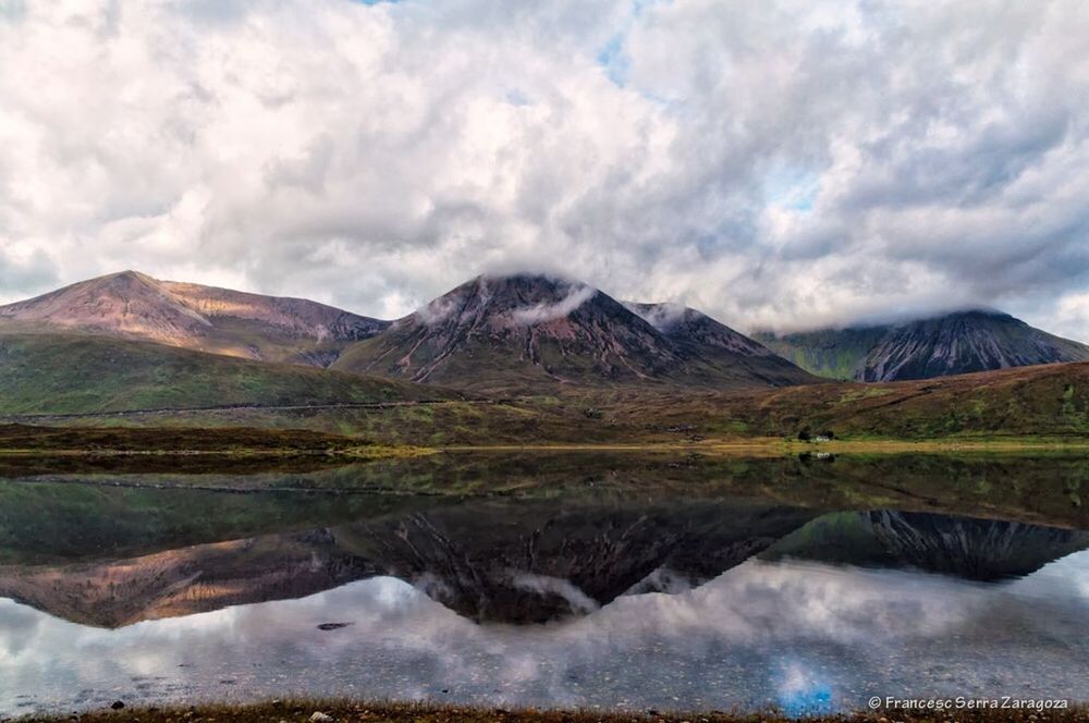 SCENIC VIEW OF MOUNTAINS AGAINST CLOUDY SKY