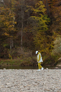 Rear view of woman walking on field